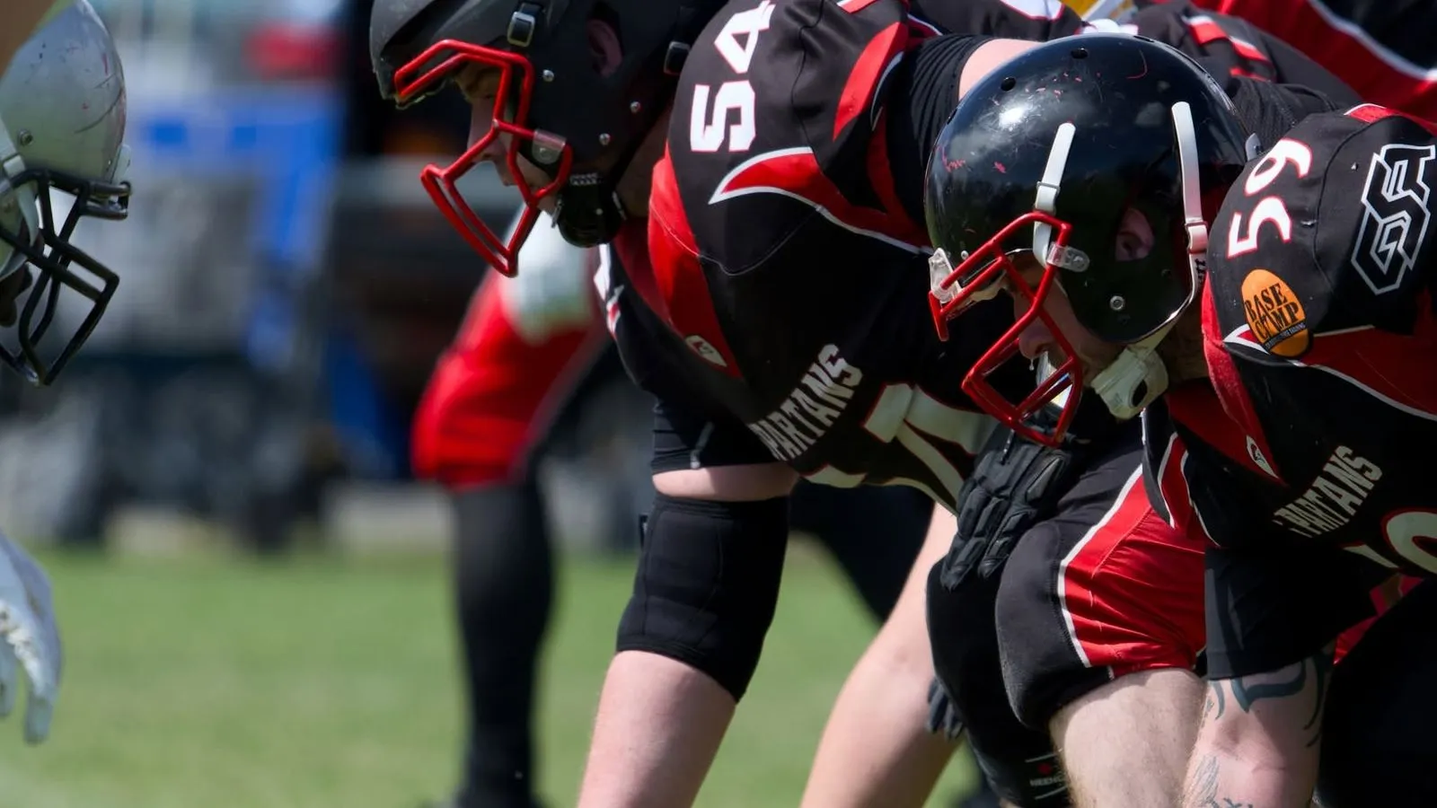 The Spartans offensive line crouches at the line of scrimmage, ready for the snap